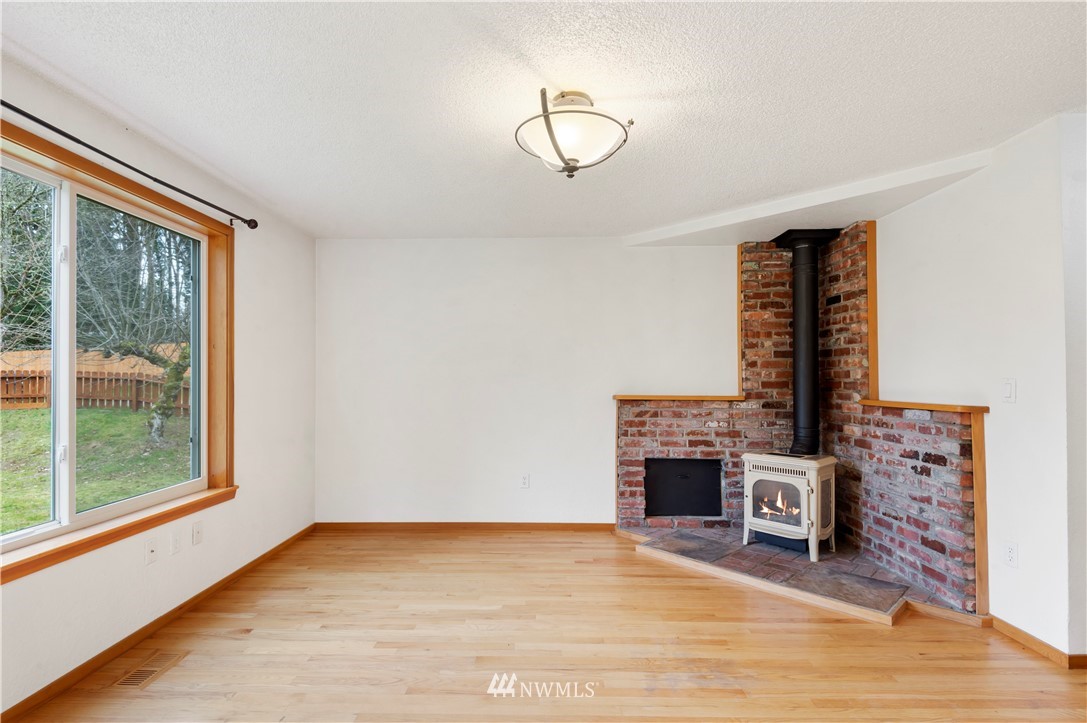 1900 Higgins Road Southeast Port Orchard, WA 98366 - Photo 3 of 26 a view of a livingroom with furniture and a fireplace