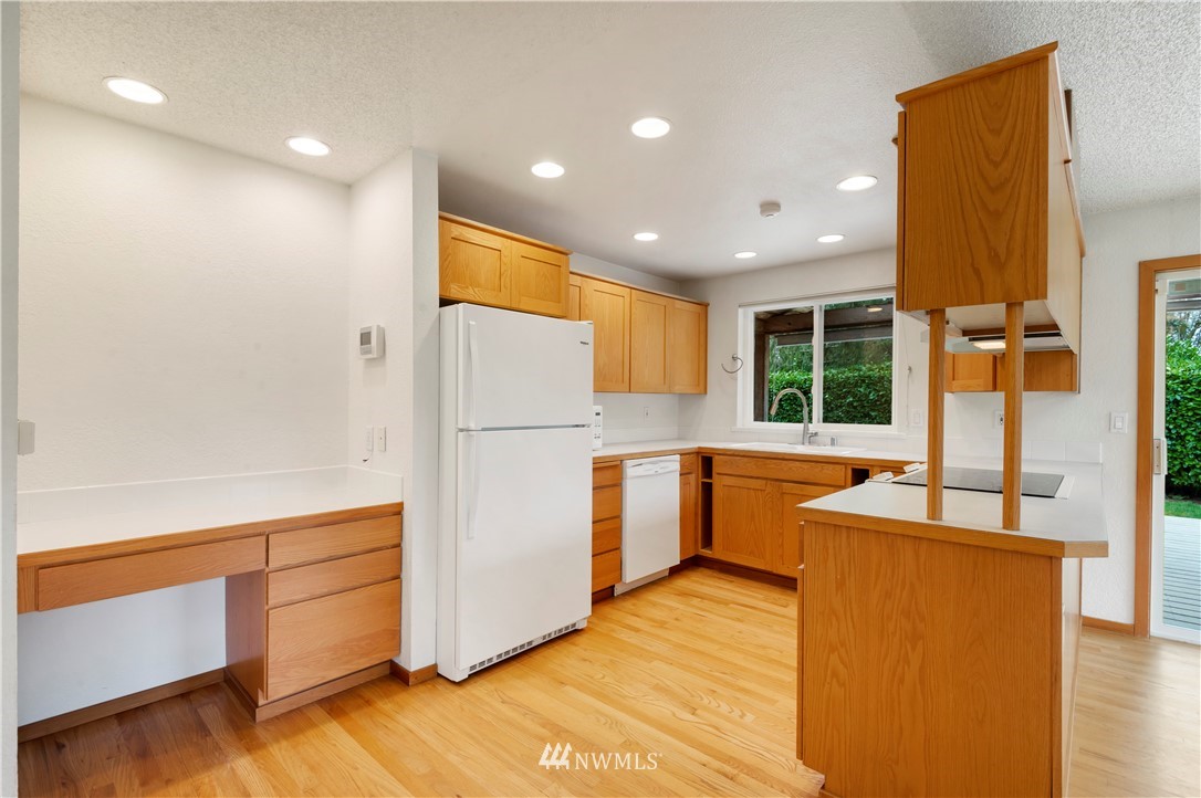 1900 Higgins Road Southeast Port Orchard, WA 98366 - Photo 6 of 26 a kitchen with stainless steel appliances granite countertop a refrigerator a sink and a stove
