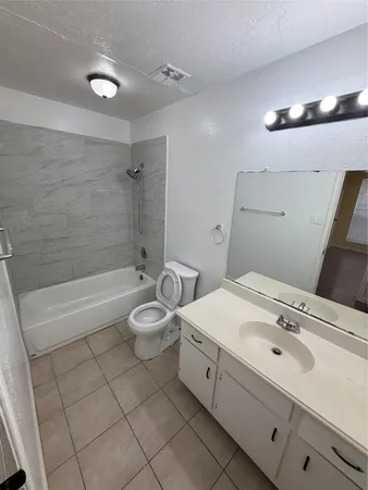 a bathroom with a double vanity sink toilet and shower