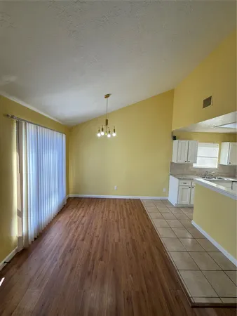 a view of a kitchen with wooden floor and a sink