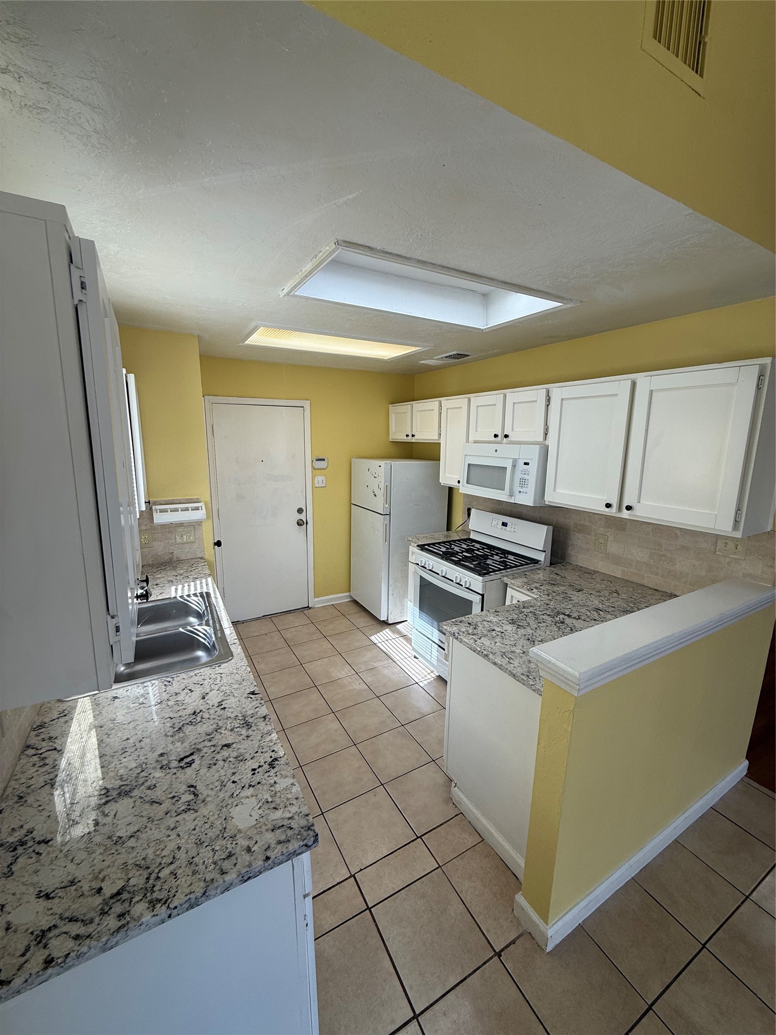 3918 Algernon Drive Spring, TX 77373 - Photo 6 of 17 a kitchen with stainless steel appliances granite countertop a sink and a stove