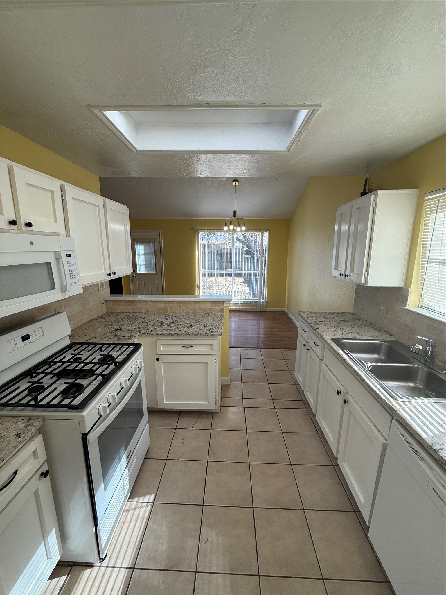3918 Algernon Drive Spring, TX 77373 - Photo 7 of 17 a kitchen with a stove a sink and a refrigerator