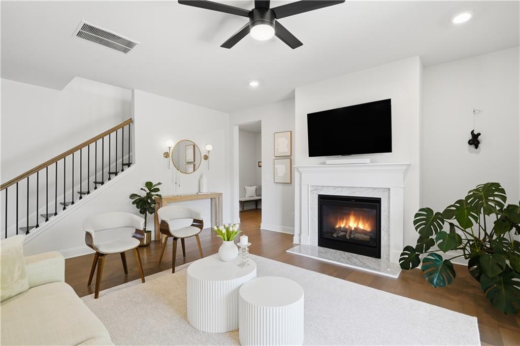 462 Carmichael Circle Canton, GA 30115 - Photo 13 of 70 a living room with furniture a fireplace and a flat screen tv
