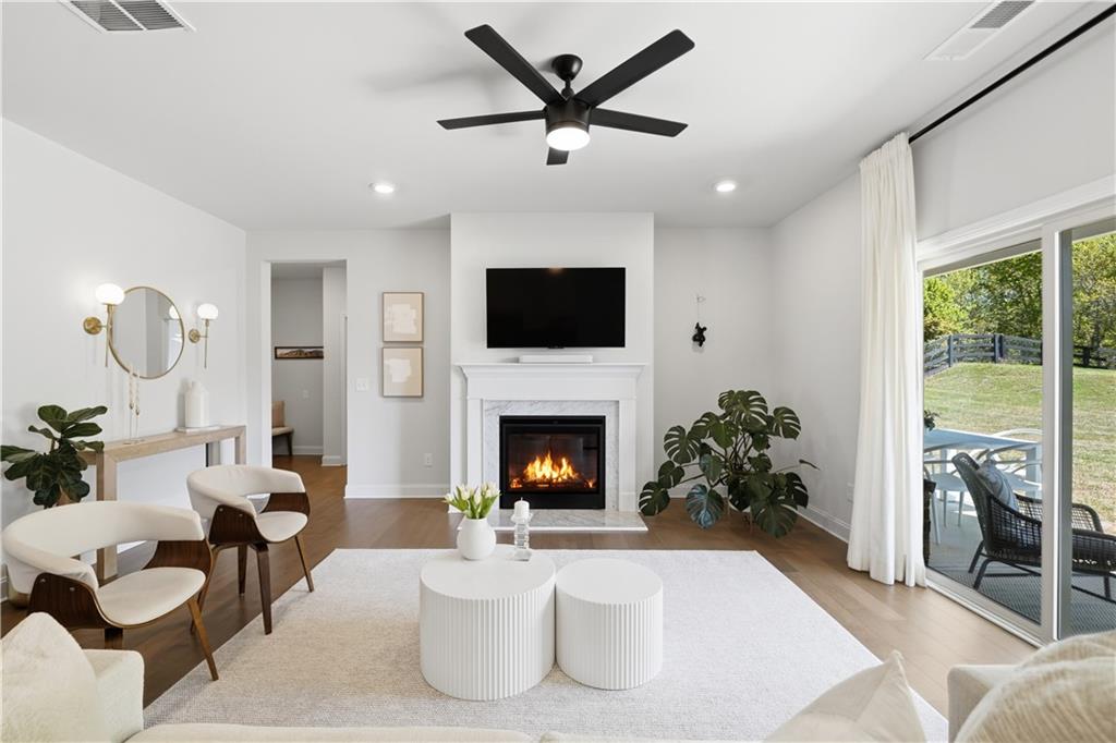 462 Carmichael Circle Canton, GA 30115 - Photo 14 of 70 a living room with furniture a fireplace and a flat screen tv