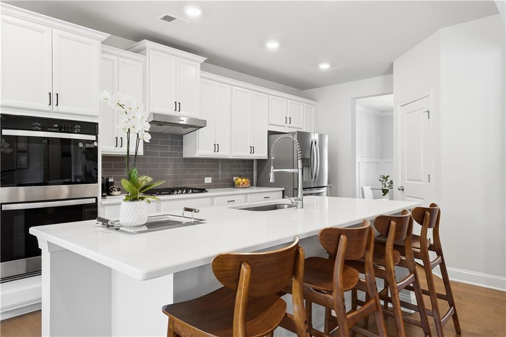 462 Carmichael Circle Canton, GA 30115 - Photo 20 of 70 a kitchen with appliances a sink and cabinets