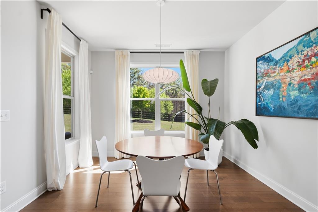 462 Carmichael Circle Canton, GA 30115 - Photo 23 of 70 a dining room with furniture a rug and wooden floor