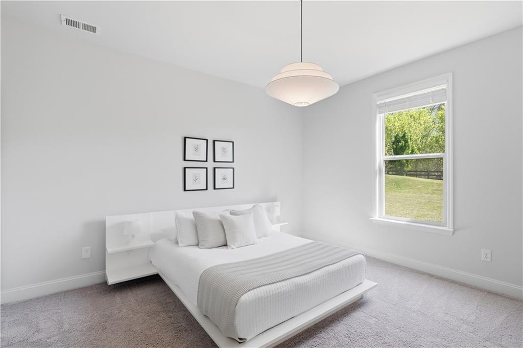 462 Carmichael Circle Canton, GA 30115 - Photo 24 of 70 a bedroom with a bed and a window