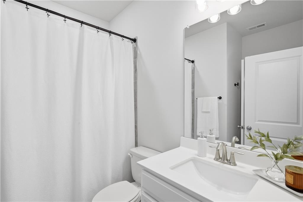 462 Carmichael Circle Canton, GA 30115 - Photo 26 of 70 a bathroom with a sink and a mirror