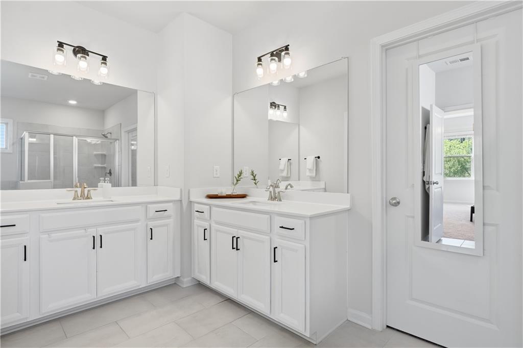 462 Carmichael Circle Canton, GA 30115 - Photo 35 of 70 a bathroom with a double vanity sink and a mirror
