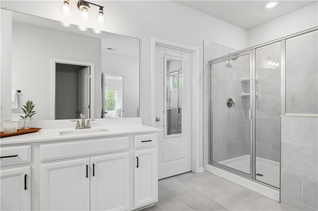 462 Carmichael Circle Canton, GA 30115 - Photo 36 of 70 a bathroom with a double vanity sink mirror and shower