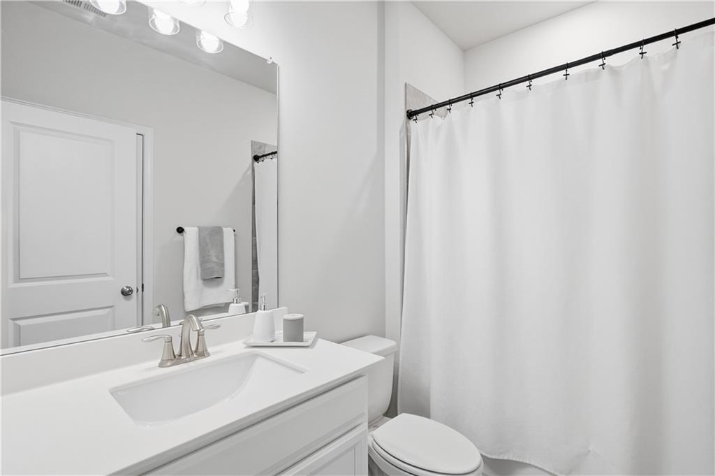 462 Carmichael Circle Canton, GA 30115 - Photo 41 of 70 a bathroom with a sink and a mirror