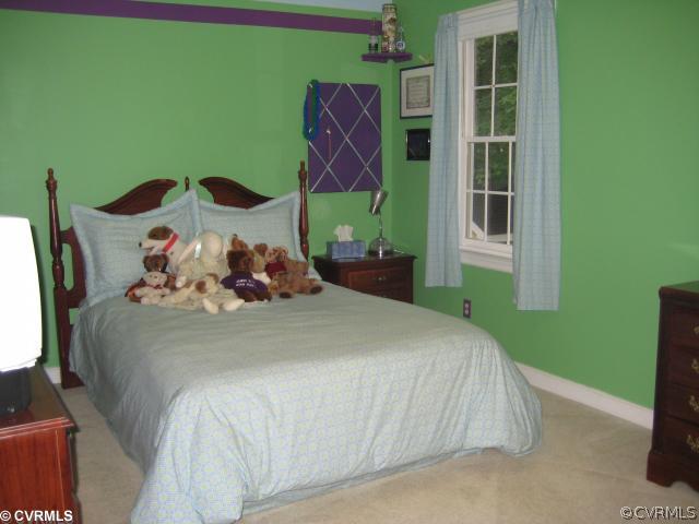 2421 Olde Stone Road Midlothian, VA 23113 - Photo 9 of 11 a bedroom with a bed and windows