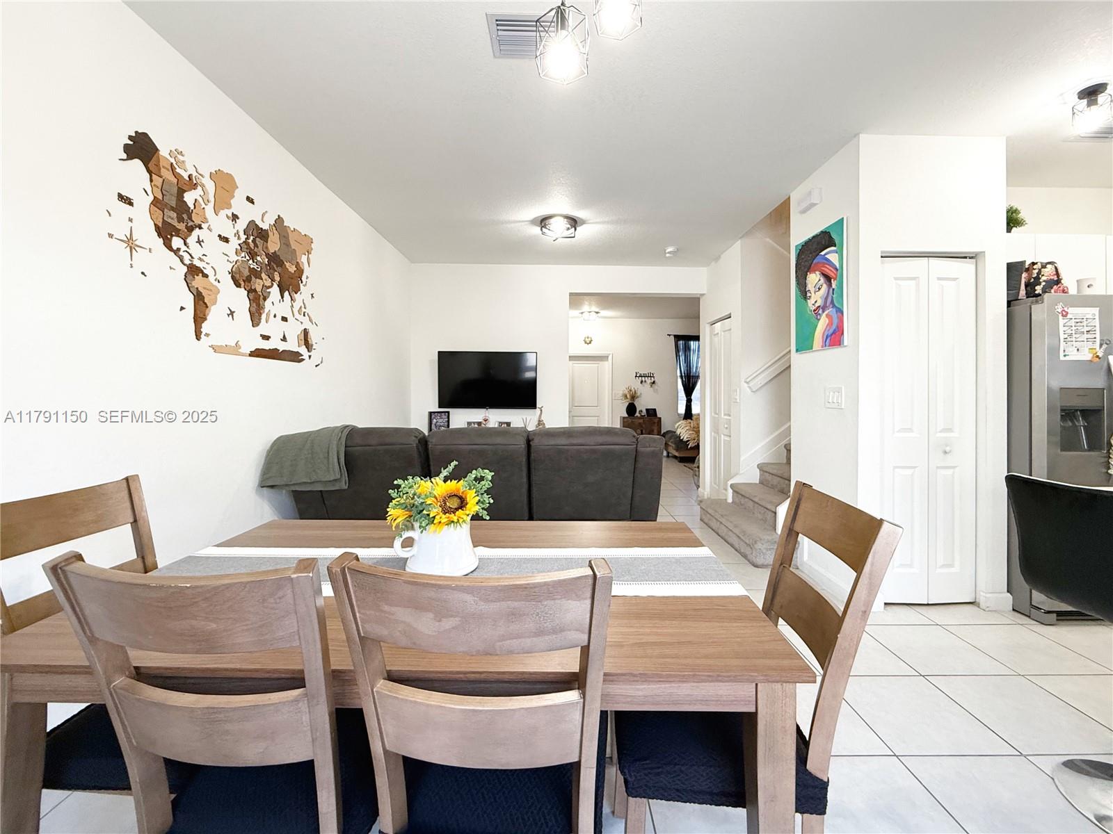 11871 Southwest 247th Terrace Homestead, FL 33032 - Photo 11 of 23 a view of a dining room with furniture and a flat screen tv