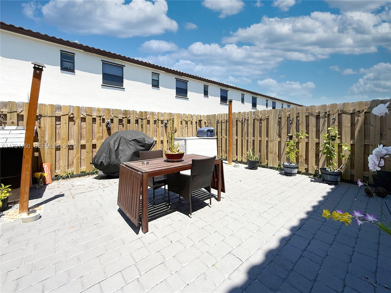 11871 Southwest 247th Terrace Homestead, FL 33032 - Photo 13 of 23 a view of a patio with a table and chairs