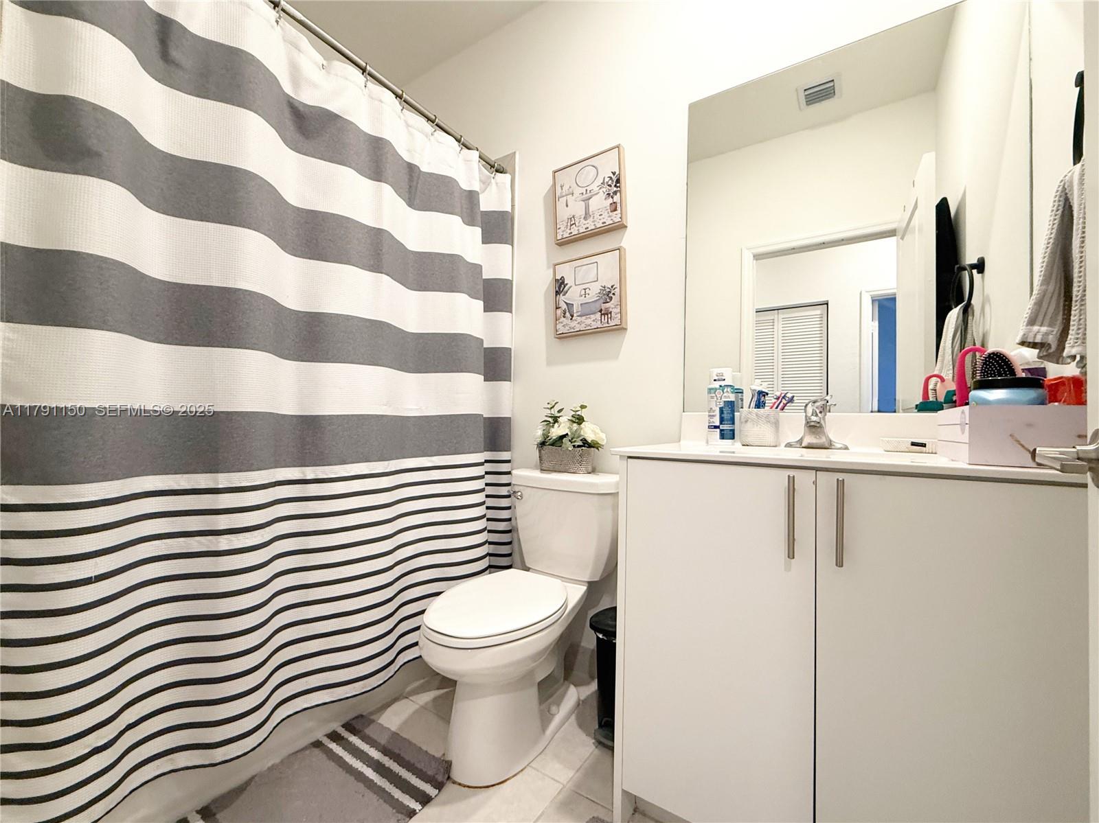 11871 Southwest 247th Terrace Homestead, FL 33032 - Photo 17 of 23 a white toilet sitting next to a bathroom sink
