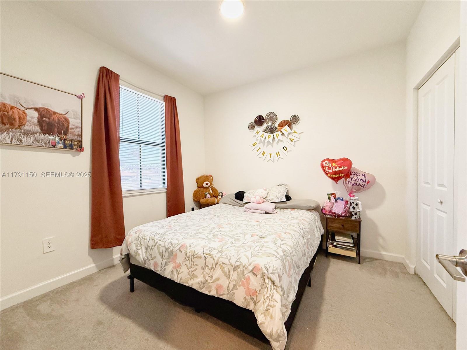 11871 Southwest 247th Terrace Homestead, FL 33032 - Photo 19 of 23 a bedroom with a bed and a window