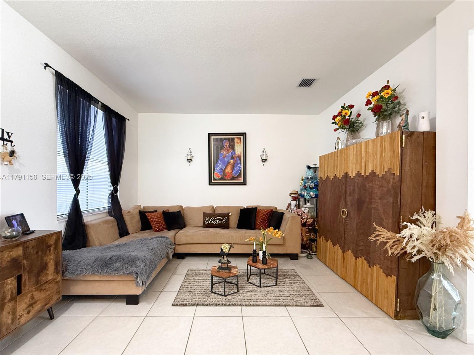 11871 Southwest 247th Terrace Homestead, FL 33032 - Photo 5 of 23 a living room with furniture and a potted plant