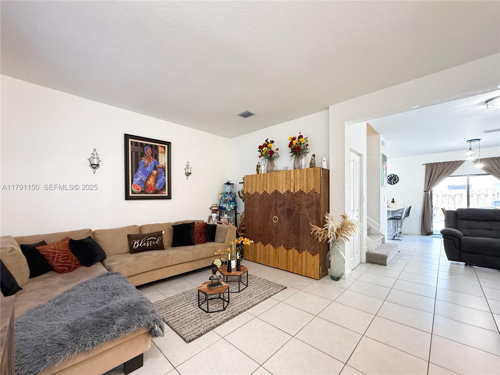 11871 Southwest 247th Terrace Homestead, FL 33032 - Photo 6 of 23 a living room with furniture and wooden floor