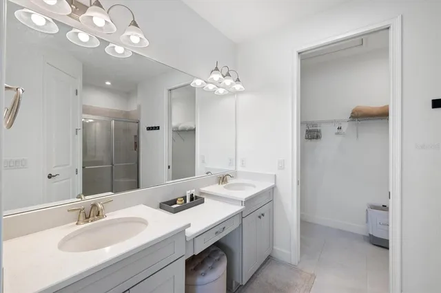 a bathroom with a sink vanity granite and a mirror