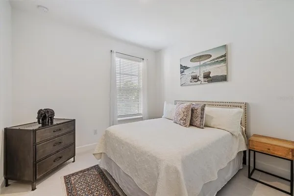 a bedroom with a bed and cabinet