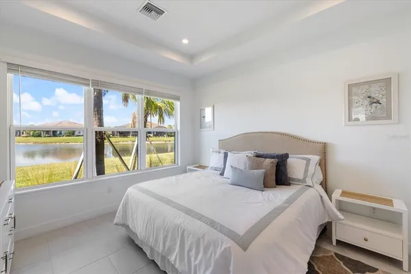 a bedroom with a large window and a bed