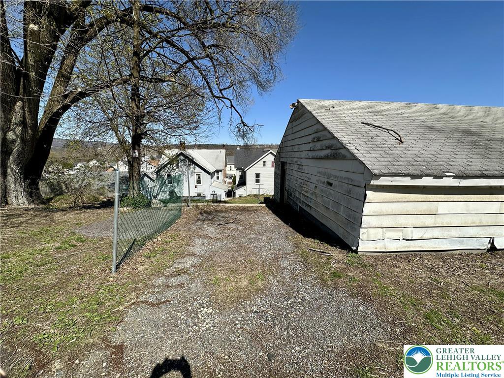 214 South Walnut Street Slatington, PA 18080 - Photo 18 of 19 a backyard of a house with large trees and wooden fence