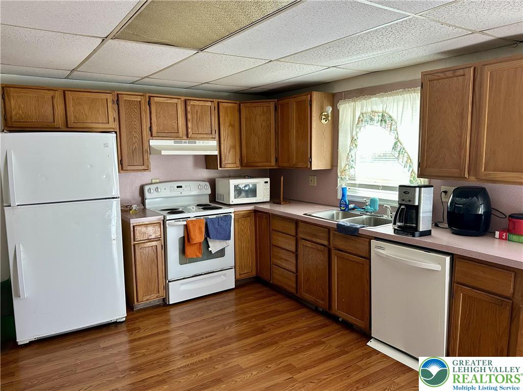 214 South Walnut Street Slatington, PA 18080 - Photo 9 of 19 a kitchen with stainless steel appliances granite countertop a refrigerator a sink dishwasher a stove and white countertops with wooden floor