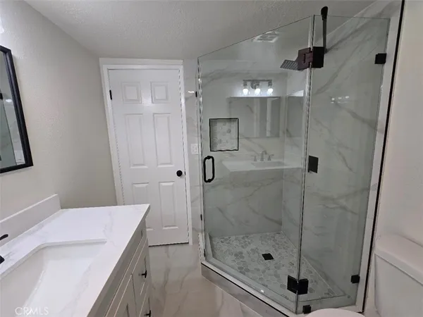 a bathroom with a shower and a sink