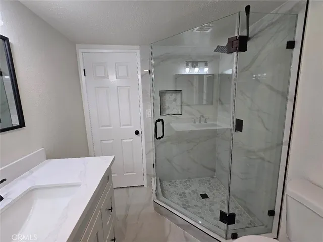 a bathroom with a shower and a sink