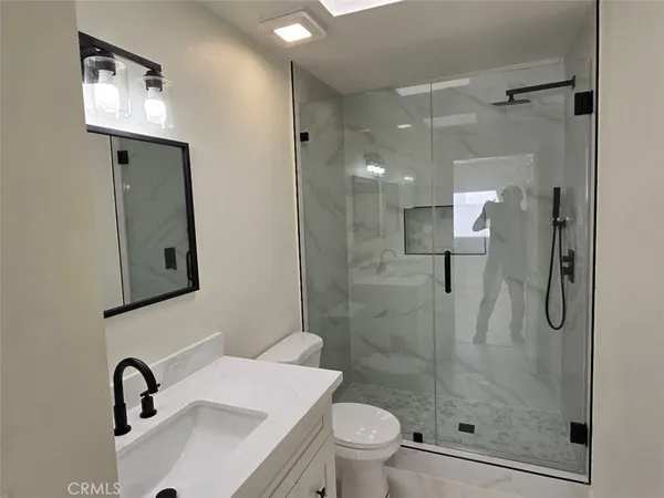 a bathroom with a sink toilet and shower