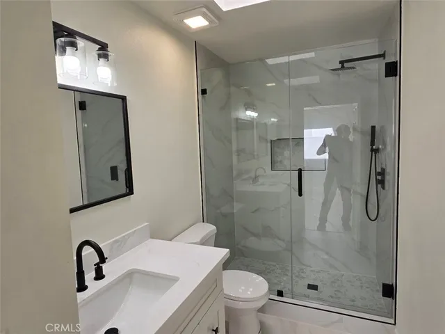 a bathroom with a sink toilet and shower