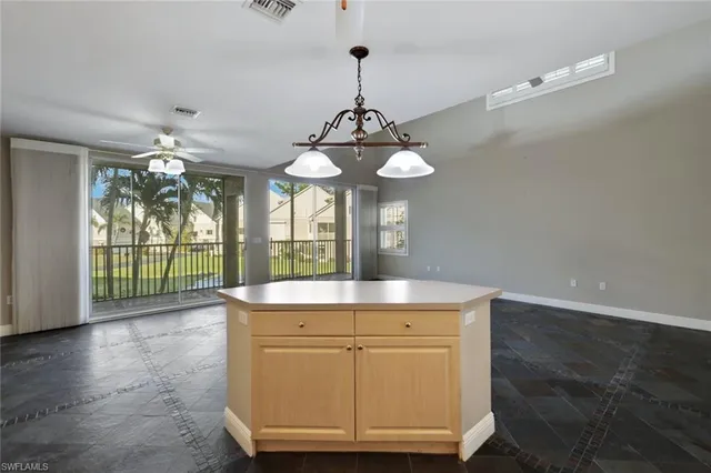 a view of a kitchen with granite countertop a sink and dishwasher with wooden floor