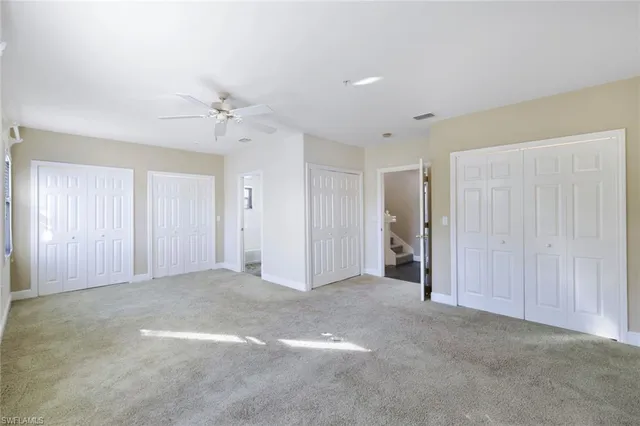 a view of empty room with a ceiling fan
