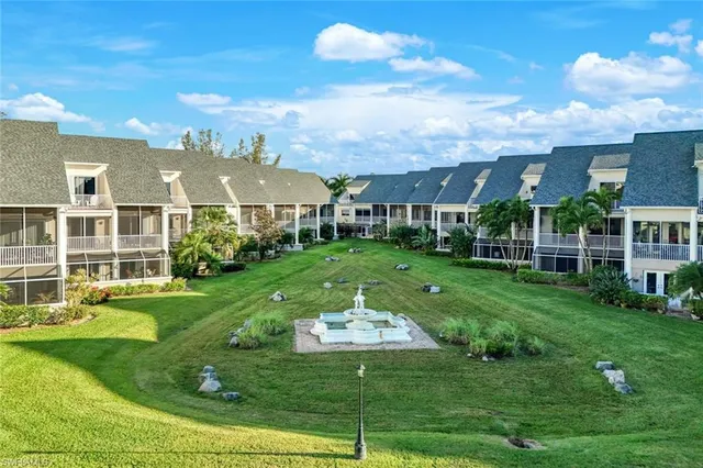 a view of a big yard with plants and large trees