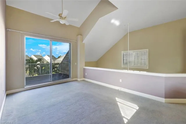 a view of a livingroom with a ceiling fan and window