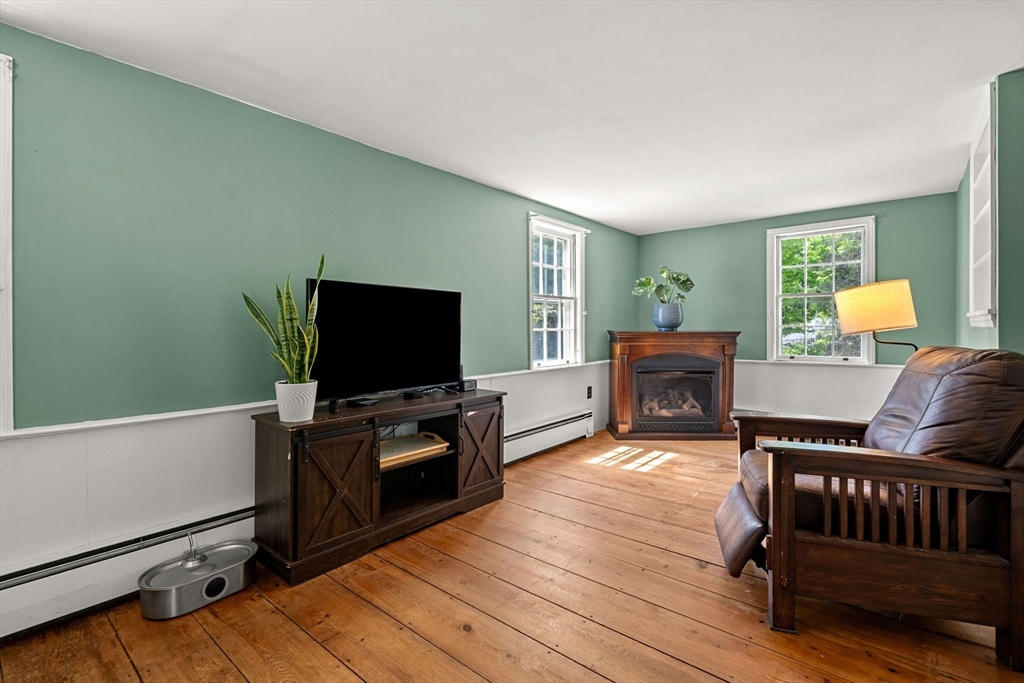 600 Main Street Ashby, MA 01431 - Photo 12 of 40 a living room with furniture and a flat screen tv