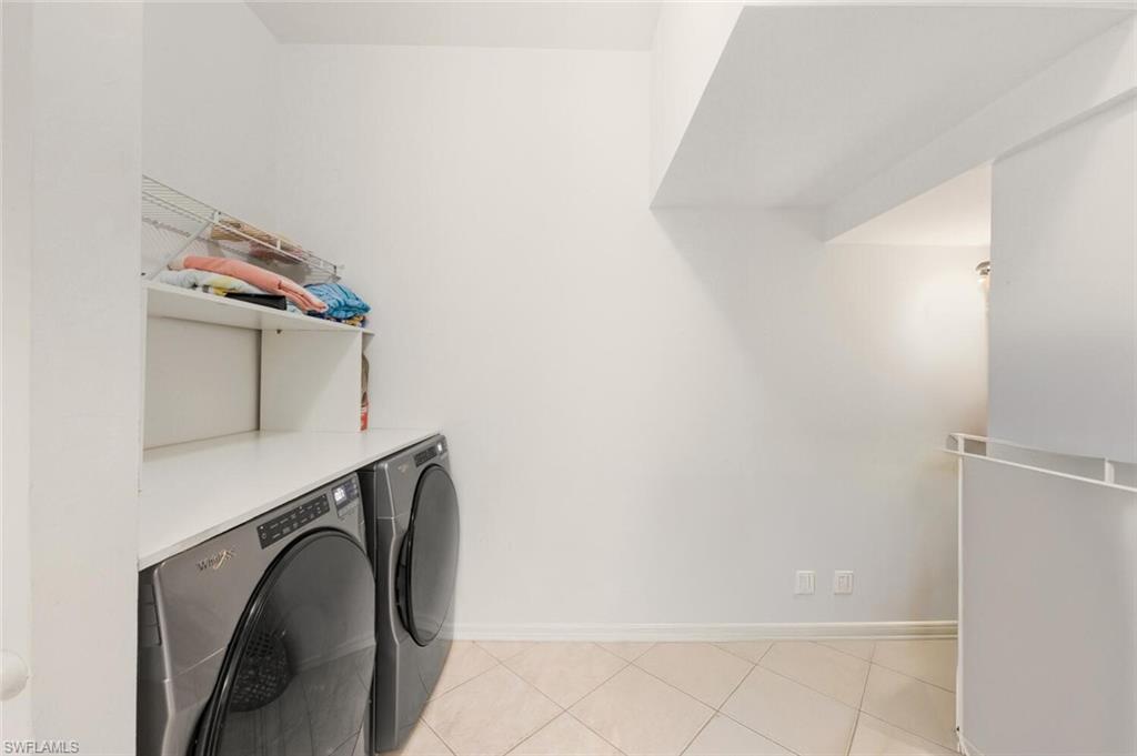14978 Summit Pl Circle Naples, FL 34119 - Photo 13 of 35 Laundry area featuring light tile patterned floors and washer and dryer