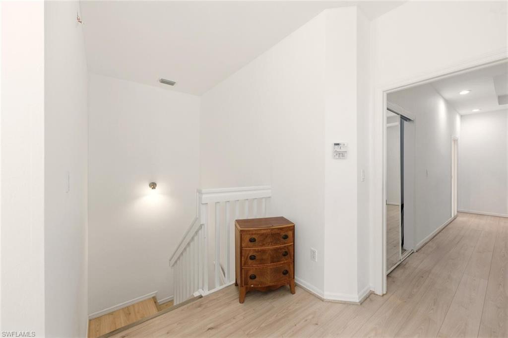 14978 Summit Pl Circle Naples, FL 34119 - Photo 14 of 35 Stairs featuring wood finished floors and recessed lighting