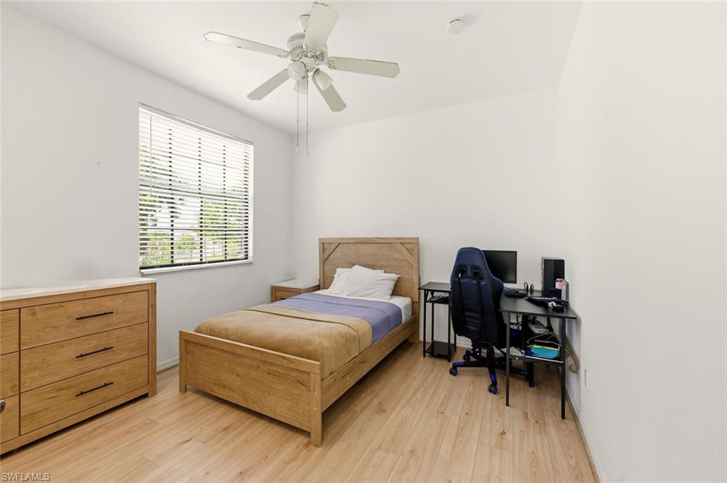 14978 Summit Pl Circle Naples, FL 34119 - Photo 20 of 35 Bedroom featuring light wood-style flooring and a ceiling fan