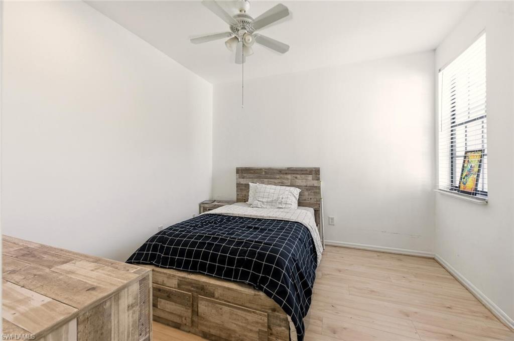 14978 Summit Pl Circle Naples, FL 34119 - Photo 22 of 35 Bedroom featuring light wood-style flooring and a ceiling fan