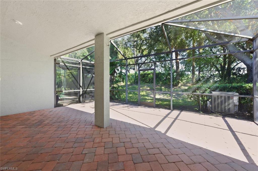 14978 Summit Pl Circle Naples, FL 34119 - Photo 24 of 35 View of patio with glass enclosure and a sunroom