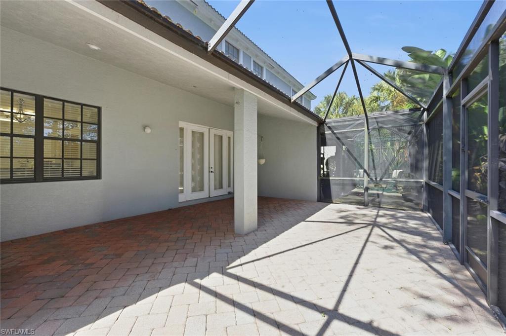 14978 Summit Pl Circle Naples, FL 34119 - Photo 25 of 35 View of patio with a sunroom, a lanai, and french doors