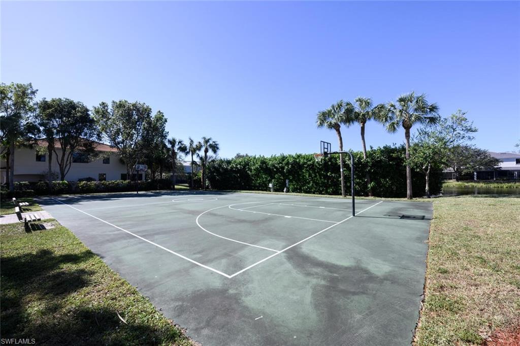 14978 Summit Pl Circle Naples, FL 34119 - Photo 35 of 35 View of sport court with community basketball court and a lawn