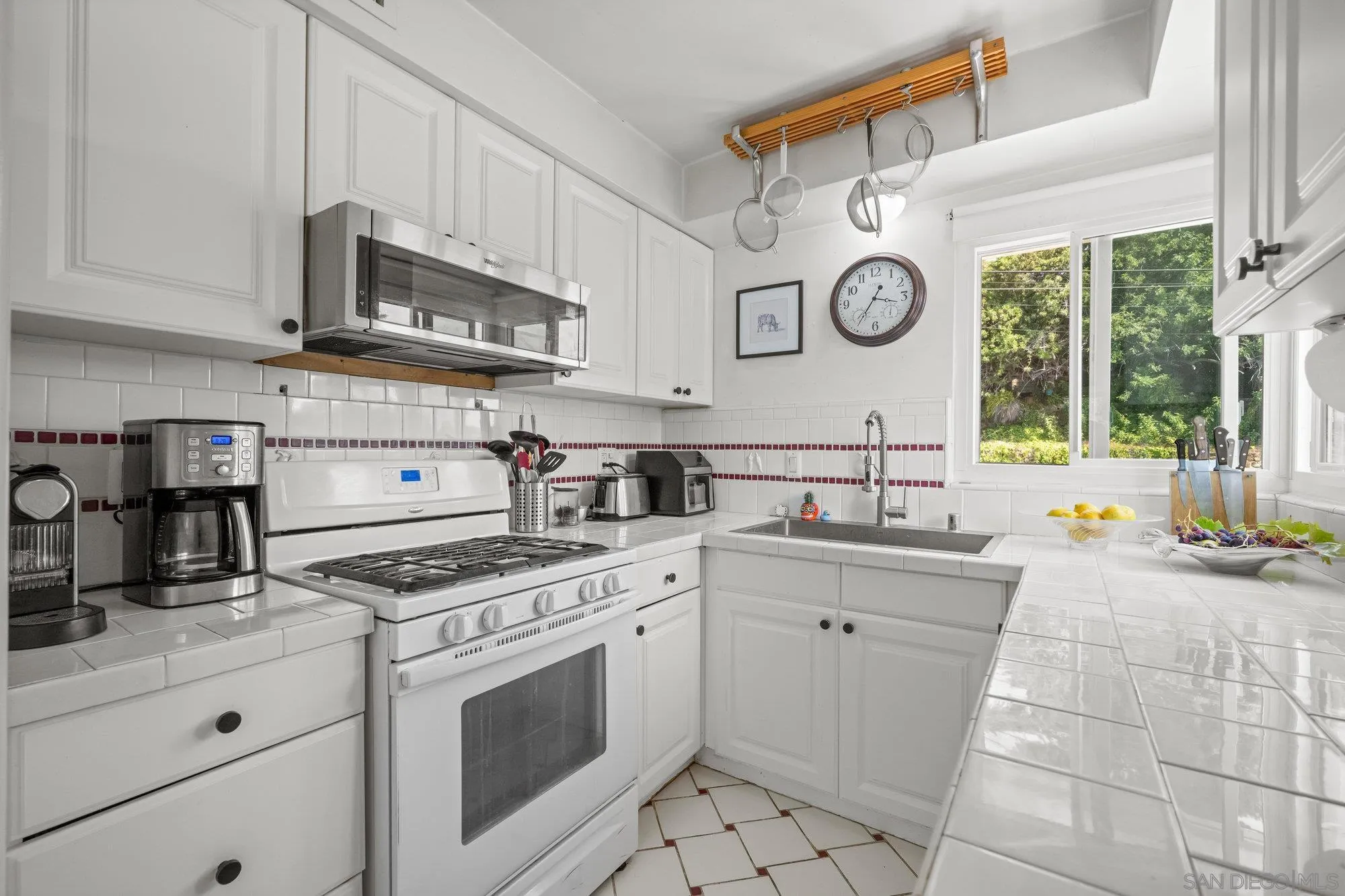 7960 Normal Avenue La Mesa, CA 91941 - Photo 13 of 42 a kitchen with stainless steel appliances a stove a sink and a cabinets