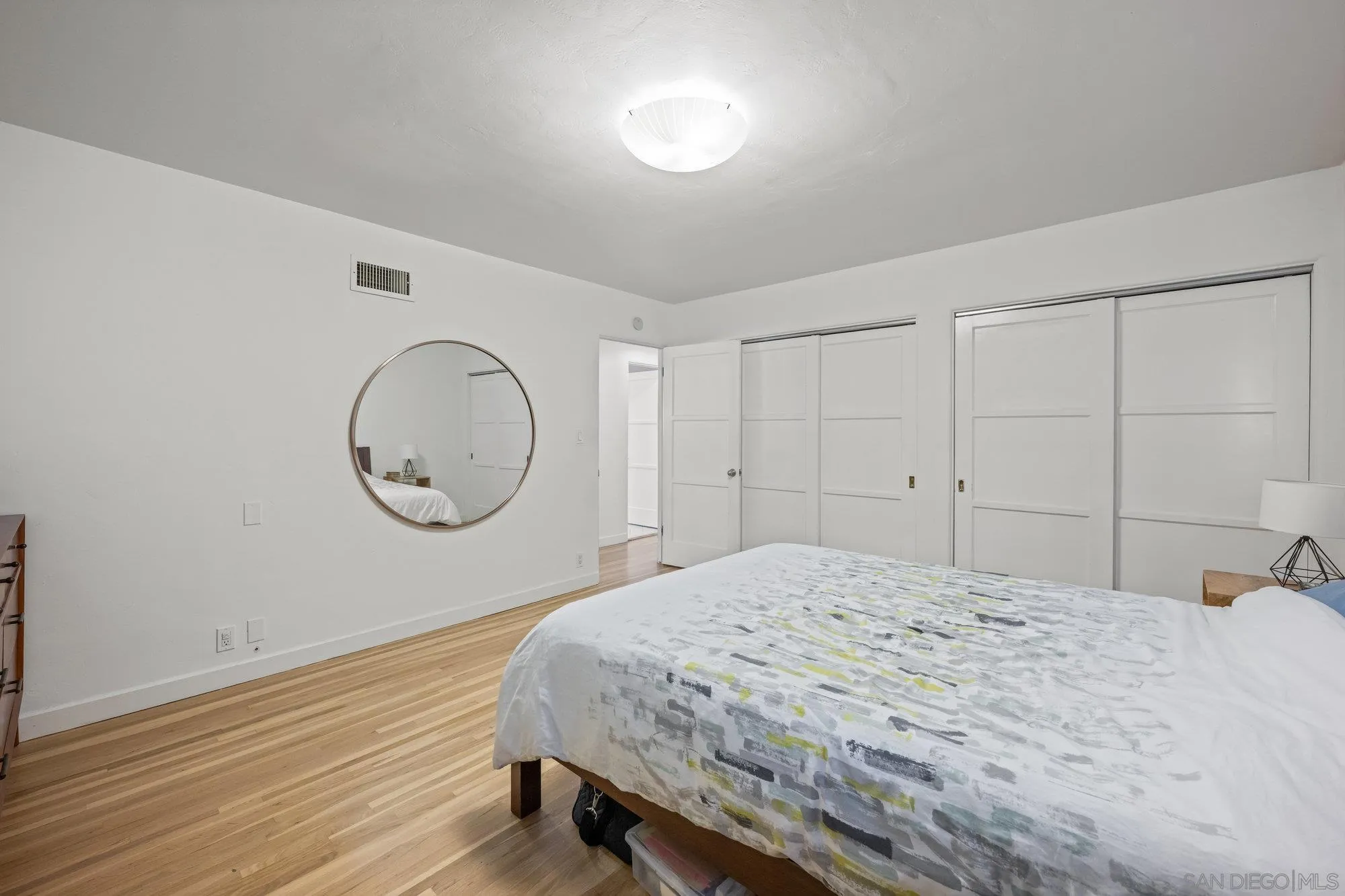 7960 Normal Avenue La Mesa, CA 91941 - Photo 17 of 42 a bedroom with a bed a mirror and a window
