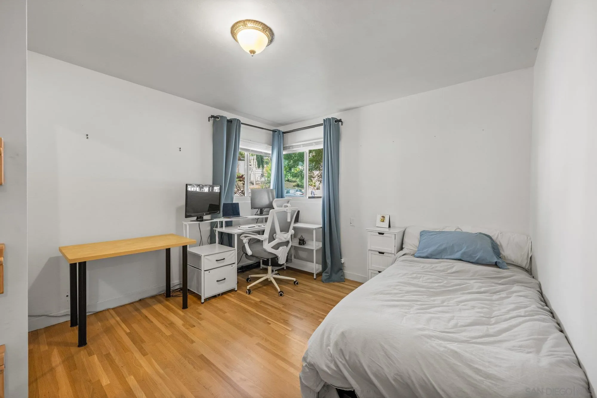 7960 Normal Avenue La Mesa, CA 91941 - Photo 18 of 42 a bedroom with a bed and a chair