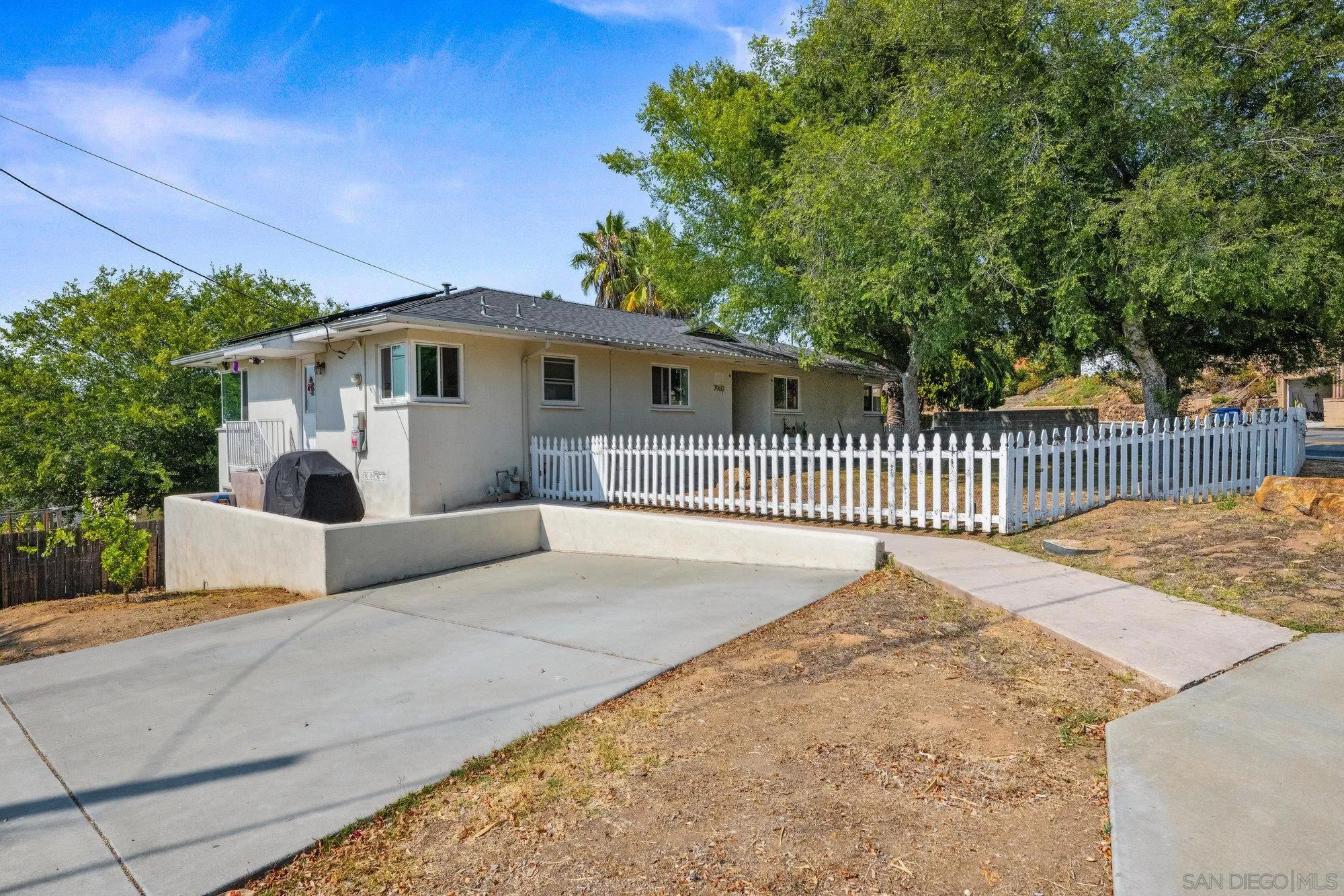7960 Normal Avenue La Mesa, CA 91941 - Photo 2 of 42 a front view of a house with a garden