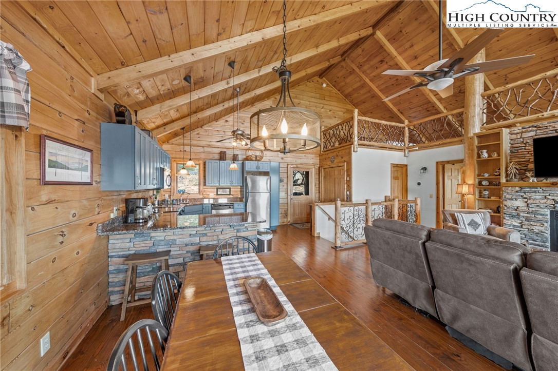 196 Eagle Nest Road Purlear, NC 28665 - Photo 15 of 36 a living room with lots of furniture and a chandelier
