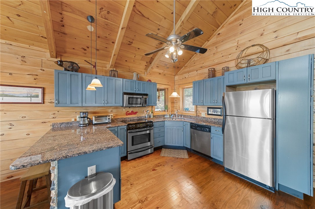 196 Eagle Nest Road Purlear, NC 28665 - Photo 18 of 36 a kitchen with granite countertop a sink appliances and cabinets