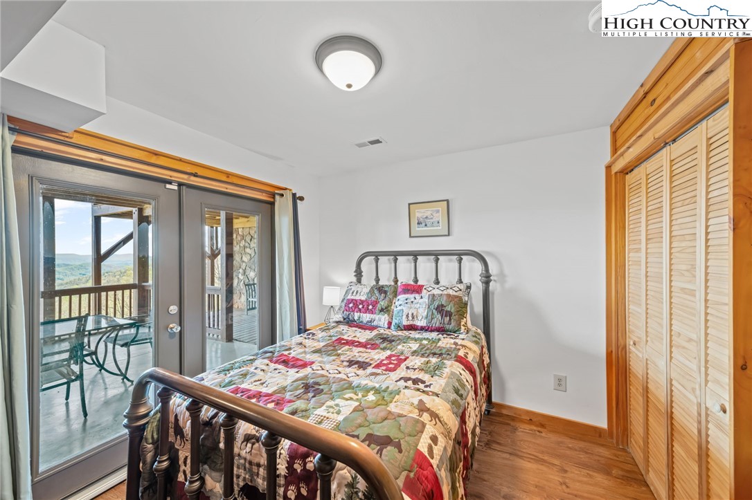 196 Eagle Nest Road Purlear, NC 28665 - Photo 26 of 36 a bedroom with a bed and a large window with outer view